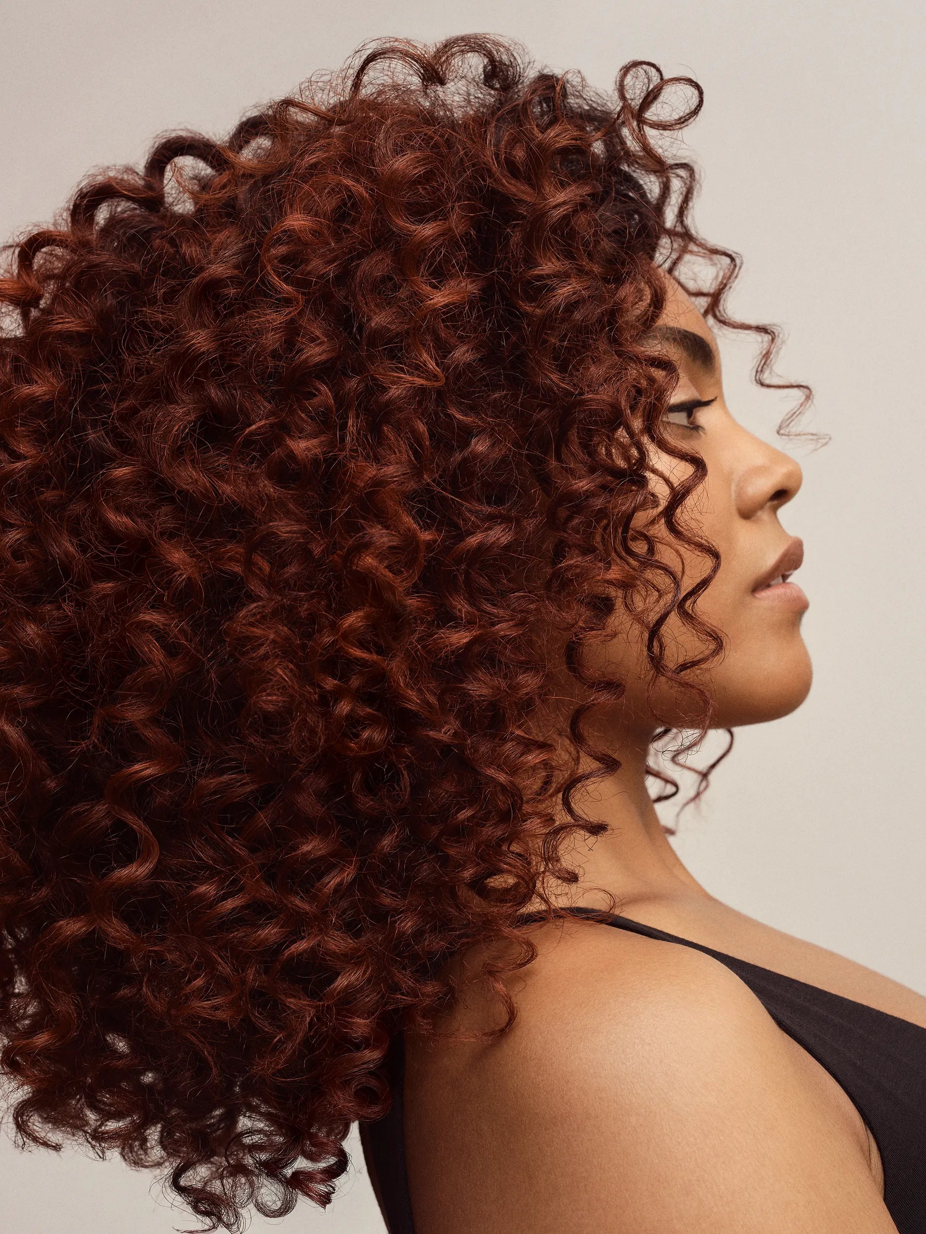 Model with long brown curly hair