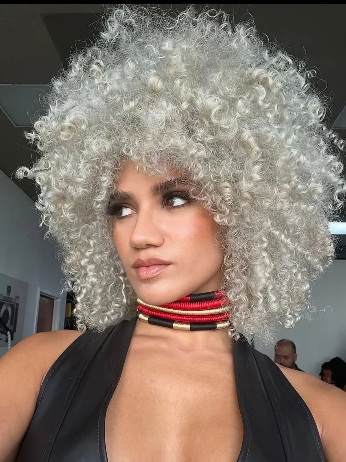 Model with full, voluminous, pearl blonde curls.