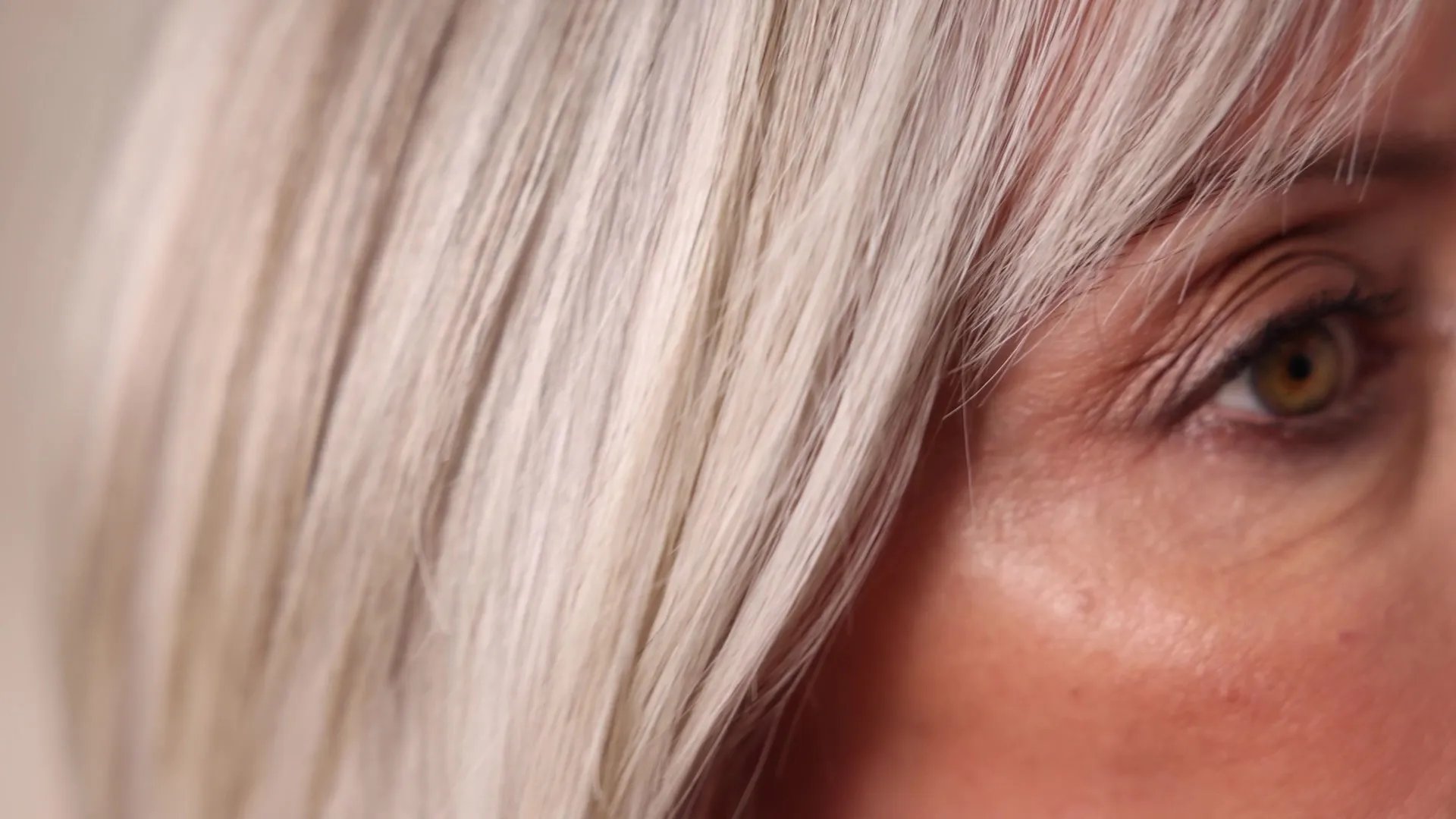 Back of model’s head with long, wavy, silver-grey hair. 