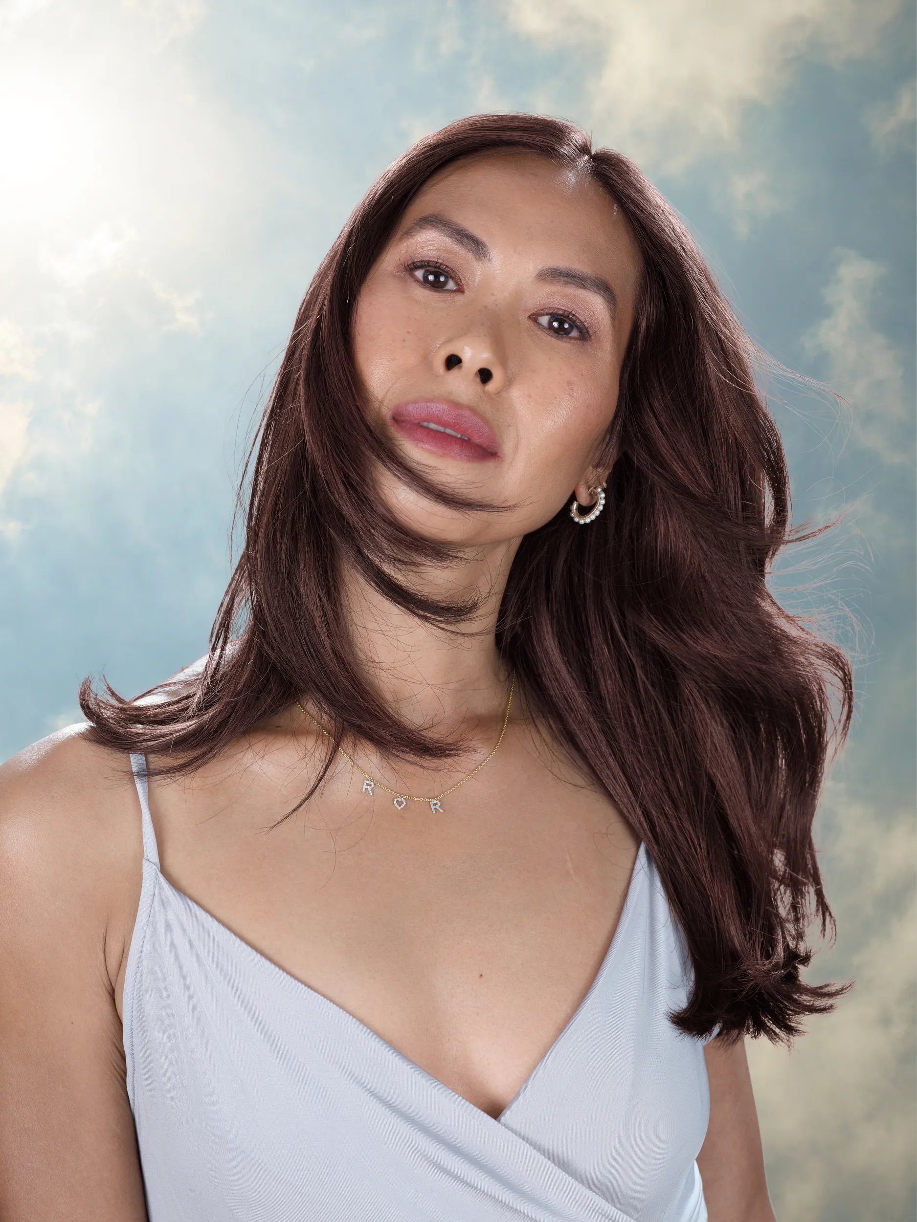Debbie Le in a white outfit against a blue sky