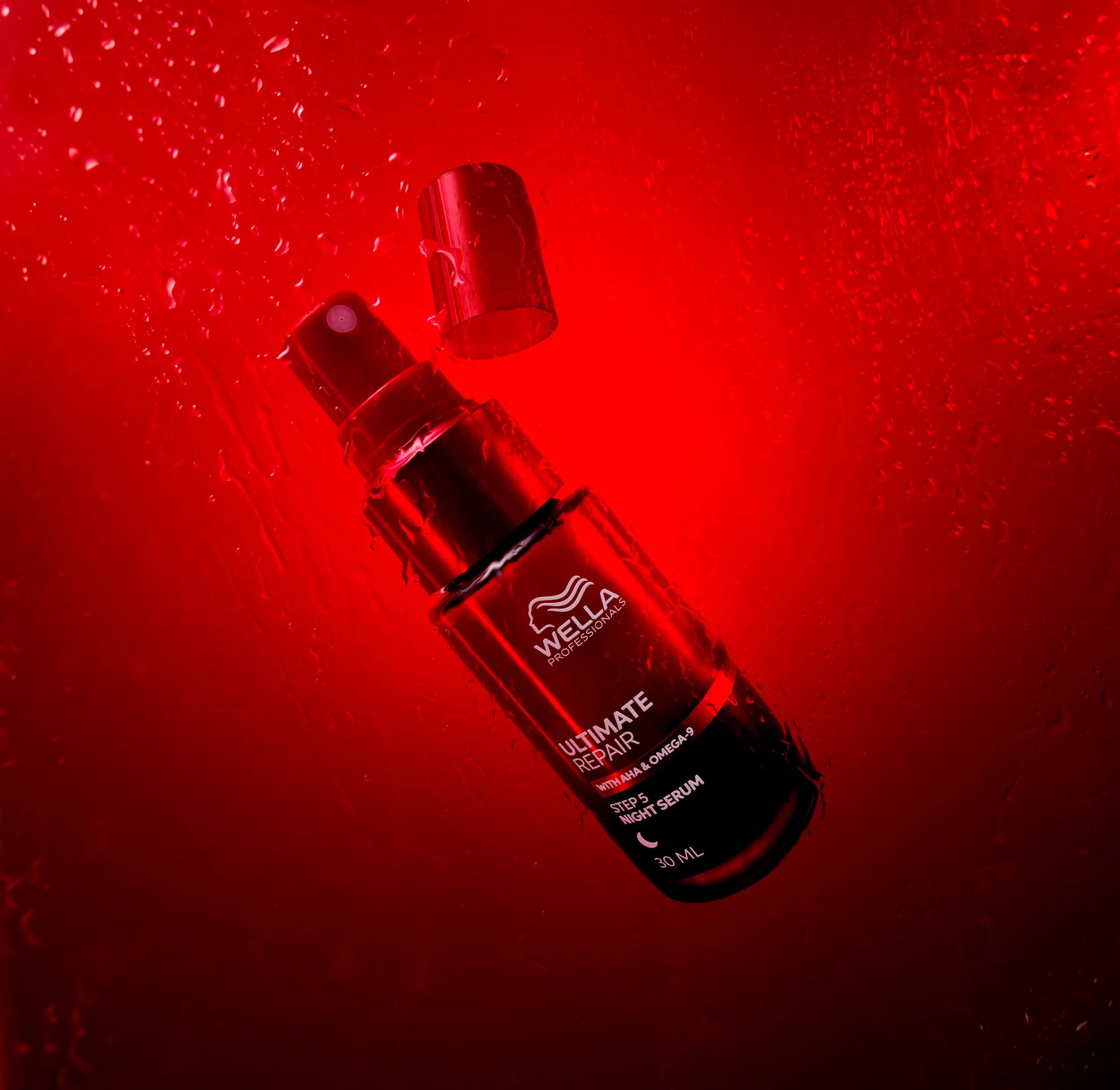 Image of Wella Ultimate Repair Night Serum over a red background