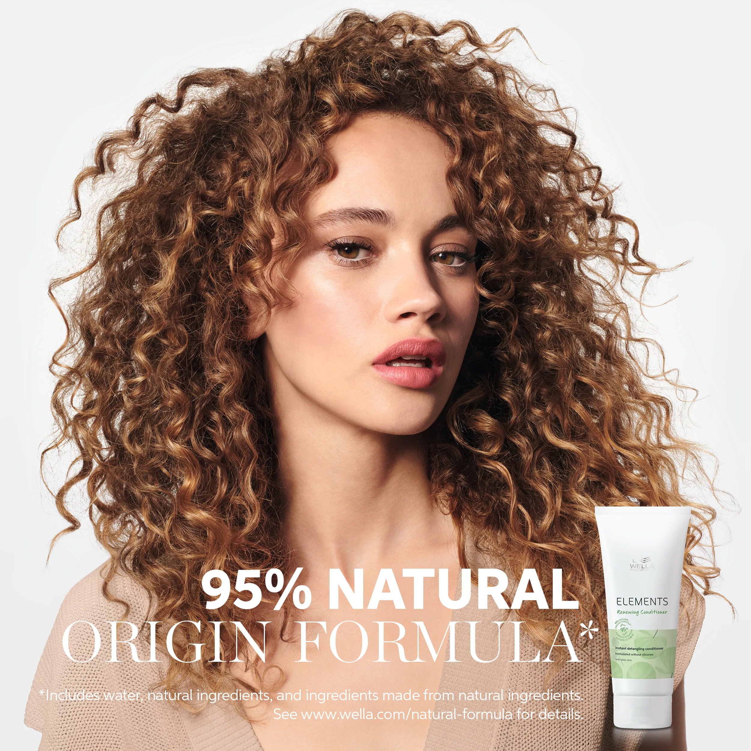 Image of a young female model with curly brown hair, with text overlaid saying '95% natural origin formula* *includes water, natural ingredients and ingredients made from natural ingredients. See www.wella.com/natural-formula for details.'