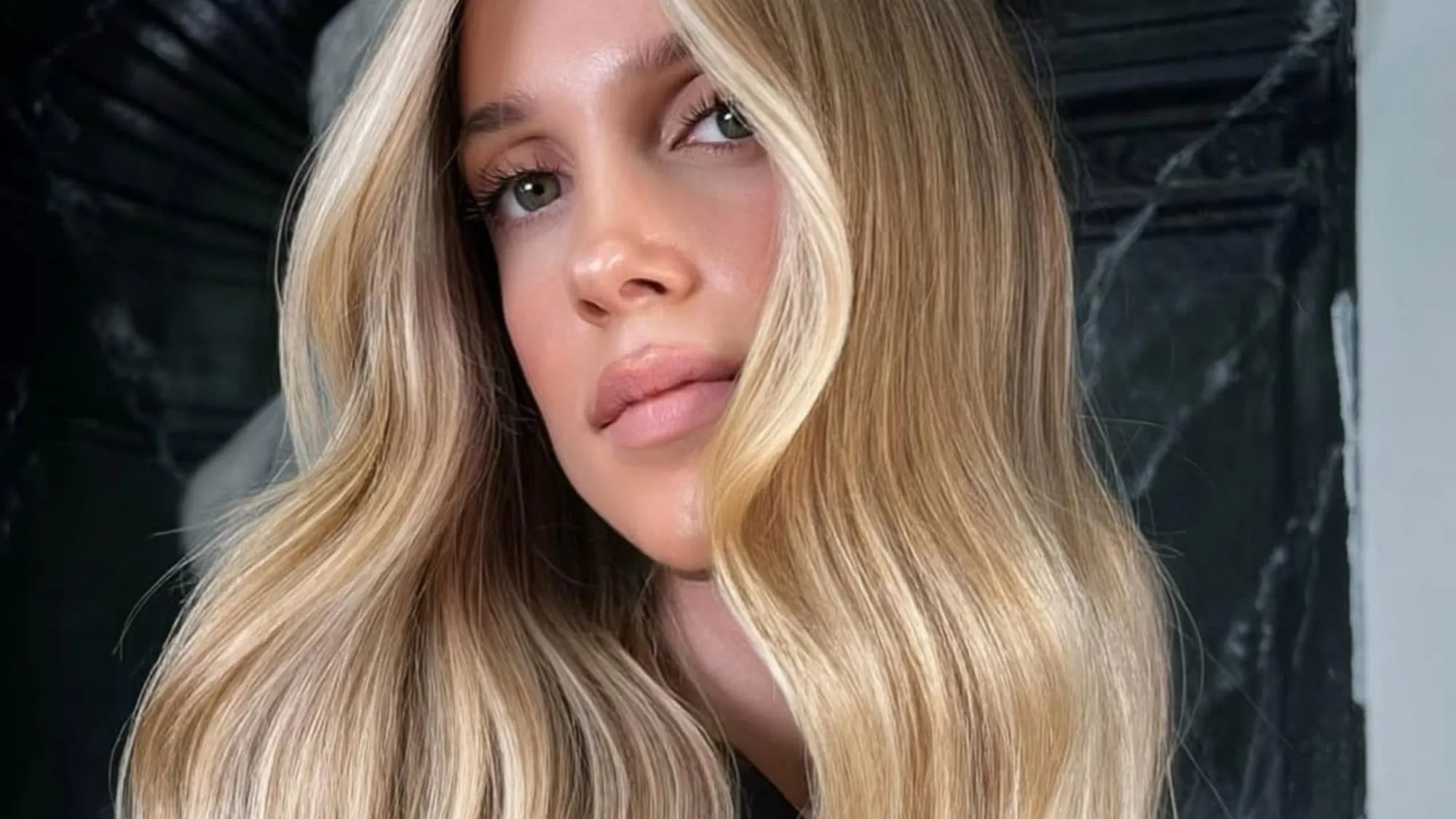 Model with long, wavy, golden butter blonde hair.