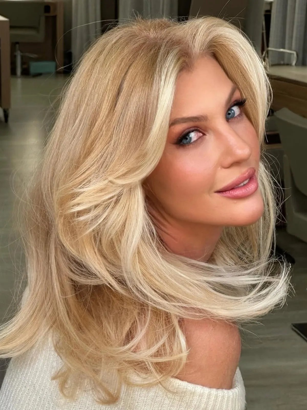 Model with bright butter blonde hair featuring a luminous face frame.