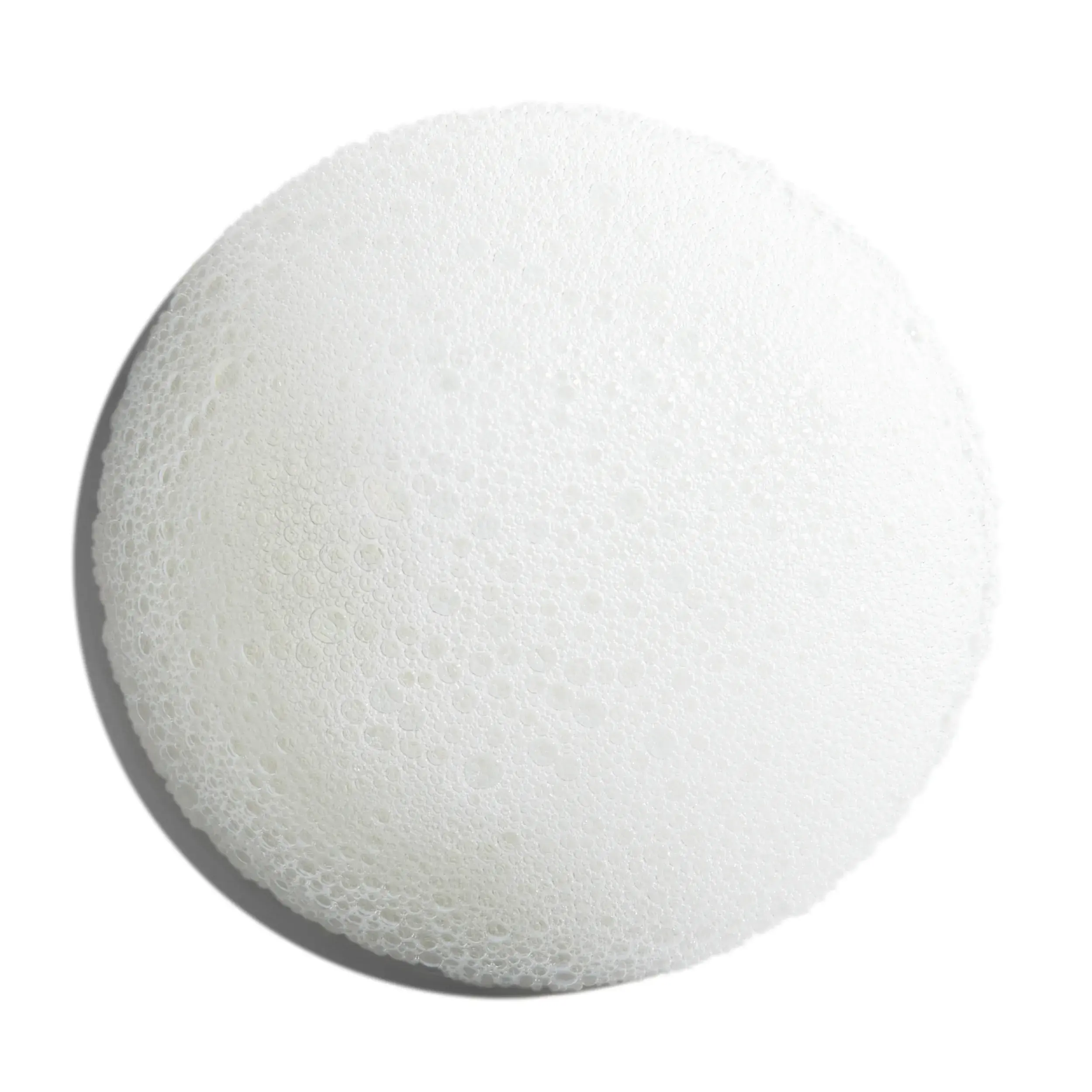 Nioxin circular white foam swatch on white surface