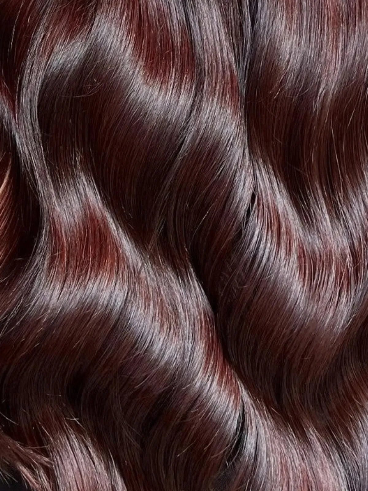 Close-up of wine maroon hair color.