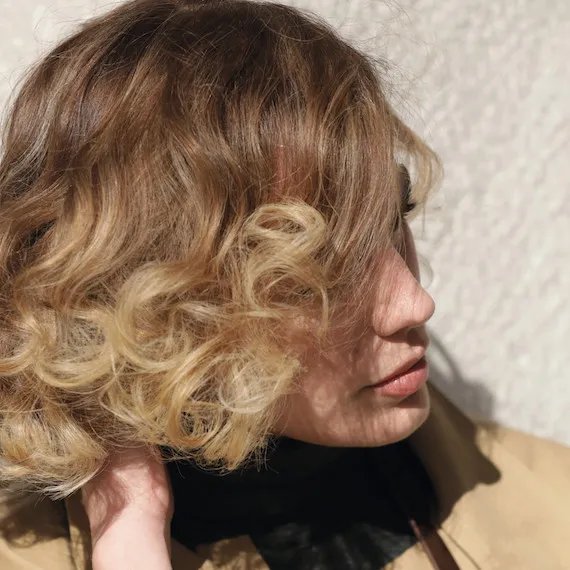 Photo of woman with short, wavy, blonde hair, created using Wella Professionals.