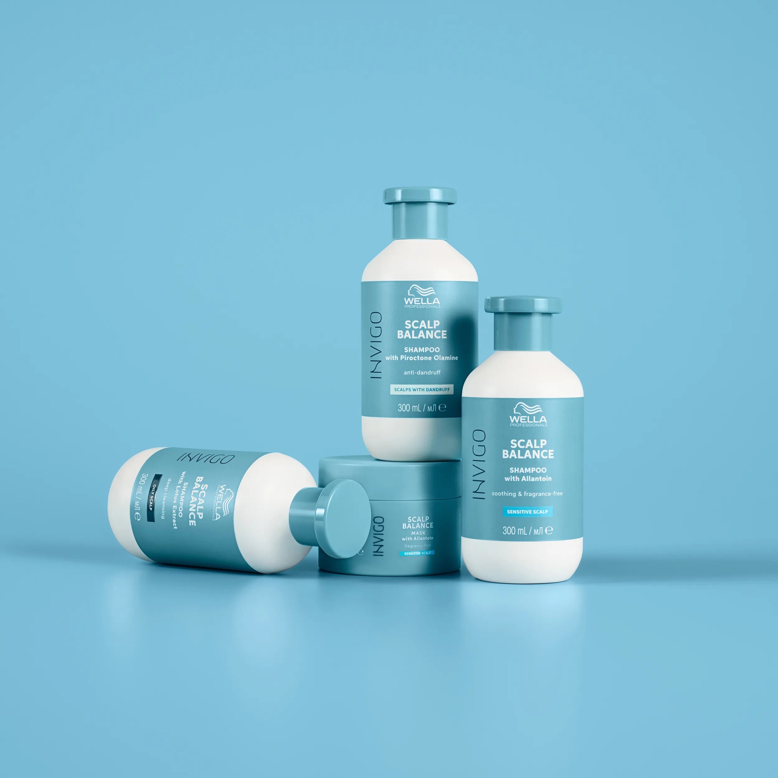 Photograph of 3 invigo scalp balance shampoos on a blue background. 