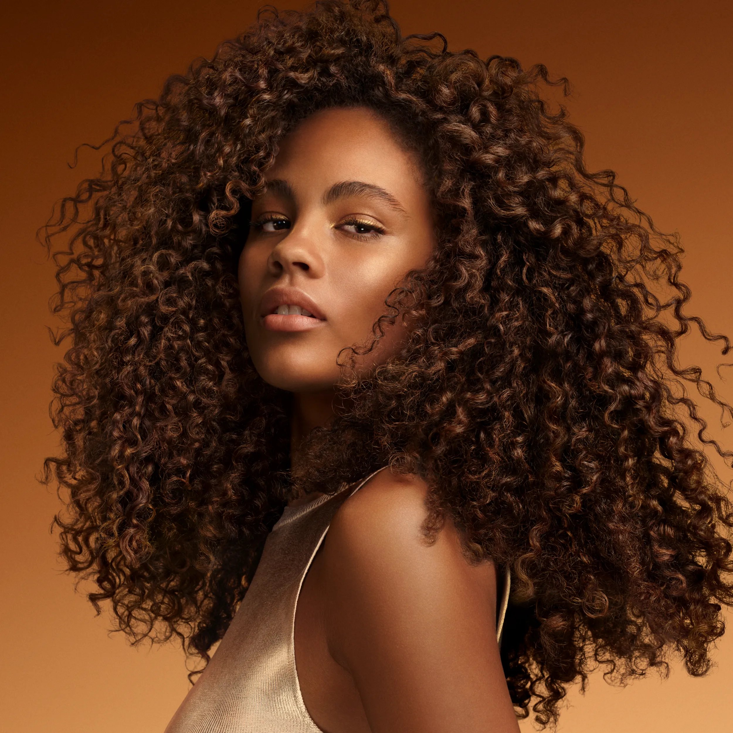 Model with curly brown long hair