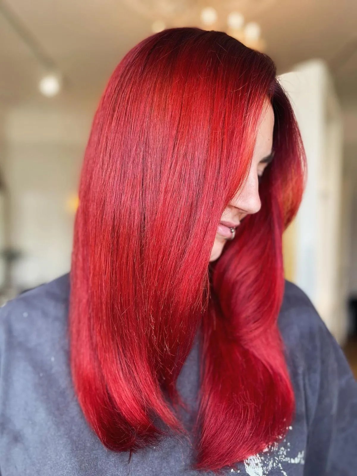 Model with velvety red hair, styled straight and sleek.