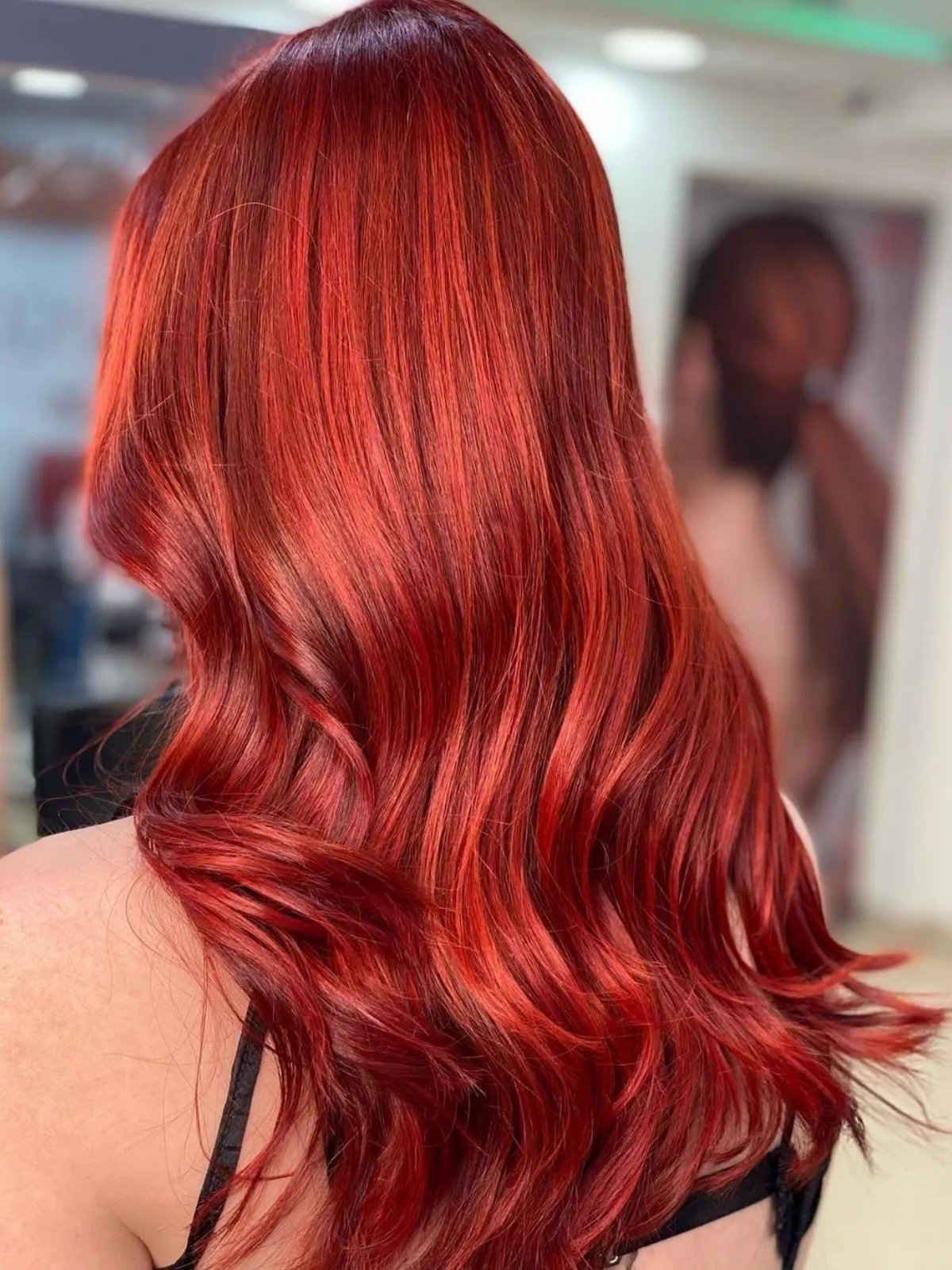 Model with long, loosely waved, bright red hair.