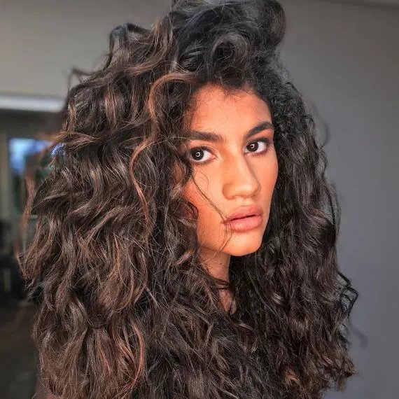Model with long, brown curly hair